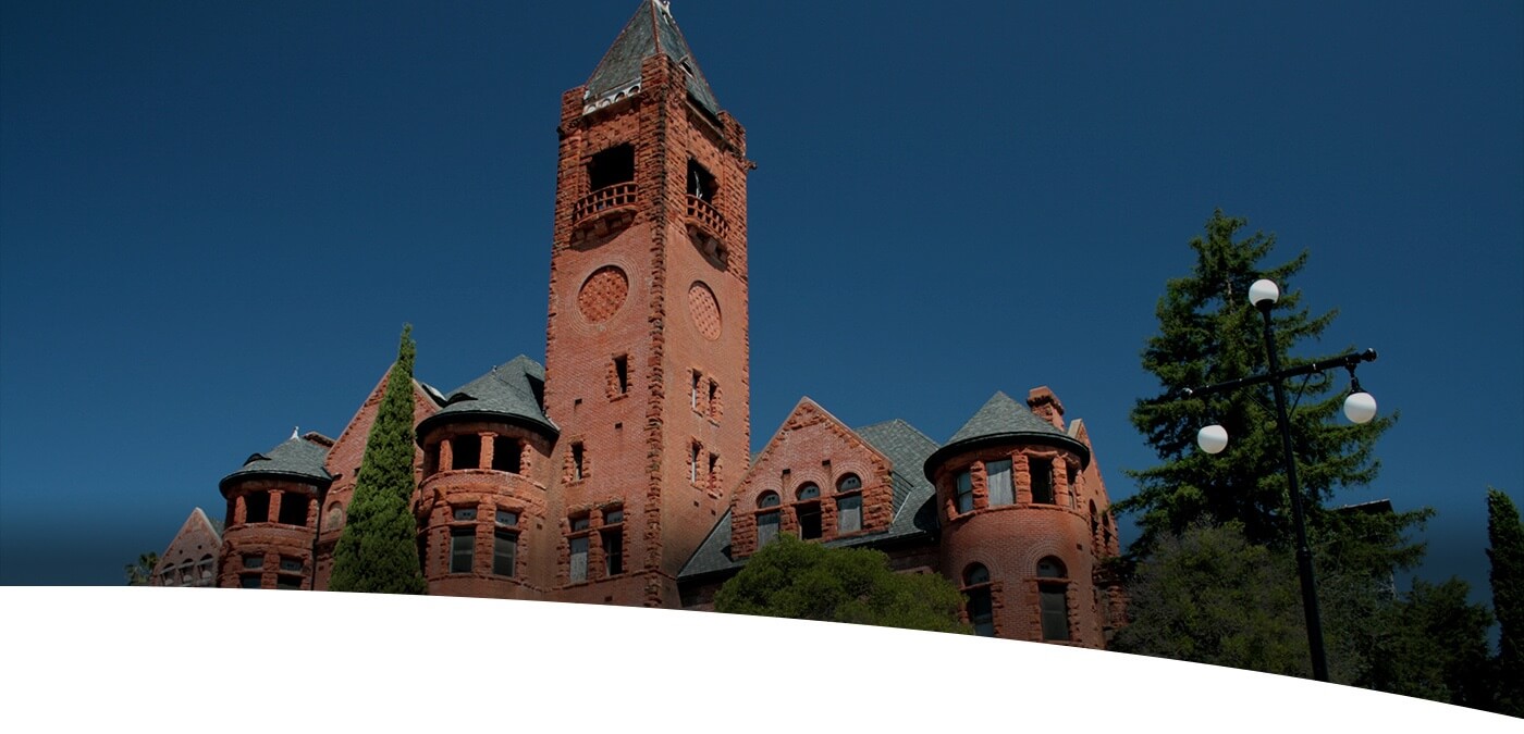 Old red brick building with green roof