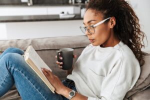 woman reading on couch 