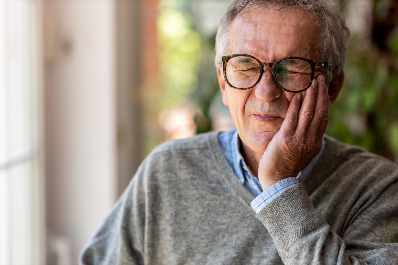 An older man experiencing a toothache