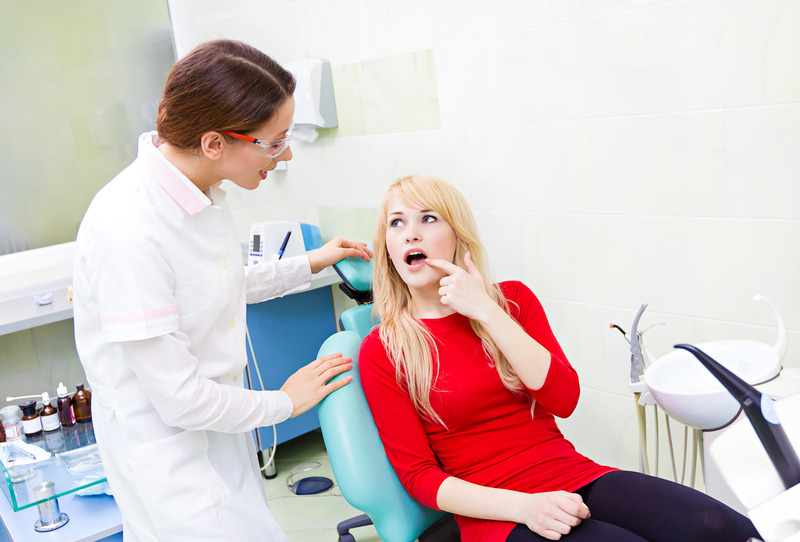 Patient at the emergency dentist holding their cheek