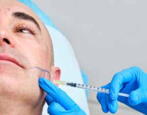 Man receiving BOTOX injection near his jaw